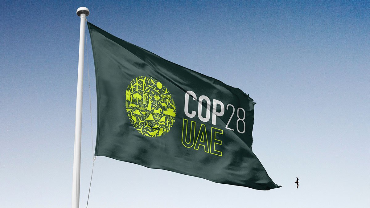 Green flag with COP28 UAE lettering.