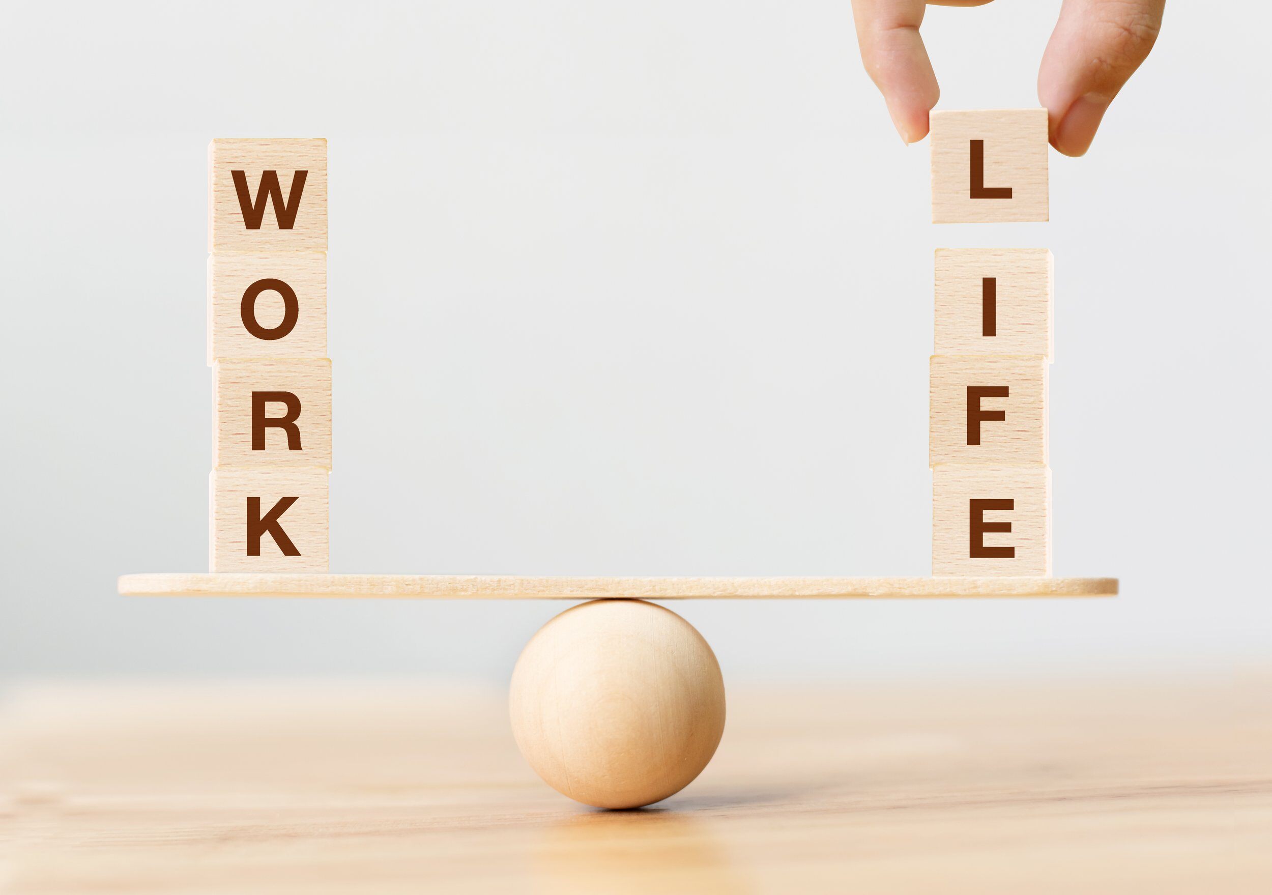 Scrabble letters of 'work' and 'life' balancing.